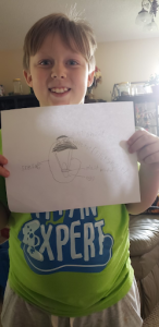 A boy holding a diagram of a parachute