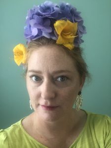 Laura Thompson wearing a hat made of flowers